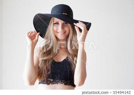 blonde girl with blue eyes a hat with a brim on a 35494142
