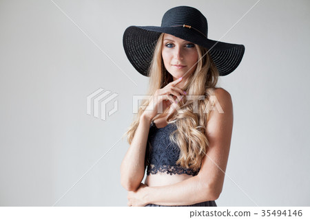blonde girl with blue eyes a hat with a brim on a 35494146