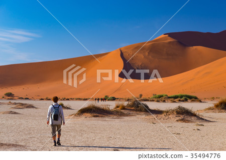 Tourist walking at Sossusvlei, Namibia Tourist walking at Sossusvlei, Namibia 35494776