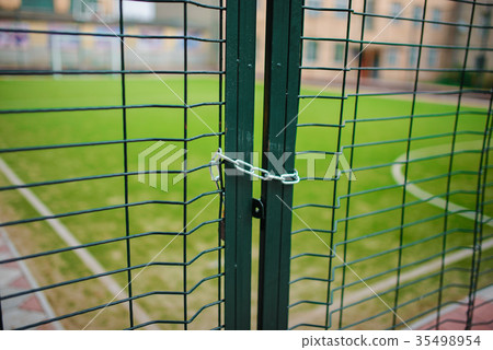 Close up metallic net-shaped green fence Close up metallic net-shaped green fence 35498954