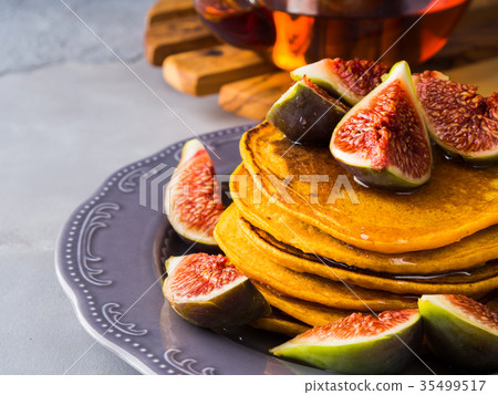 Stack of pumpkin pancakes with figs and honey Stack of pumpkin pancakes with figs and honey 35499517