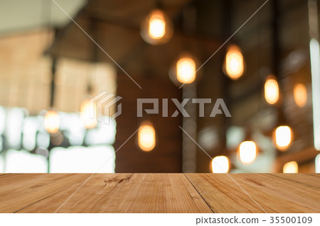 Wood board emtpy table in front of blurred shop Wood board emtpy table in front of blurred shop 35500109