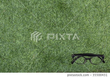 Eyeglasses on green artificial grass copy space Eyeglasses on green artificial grass copy space 35500431