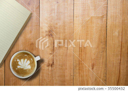 Empty book and hot coffee over wooden board table 35500432
