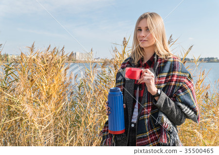 Blond woman drinking tea 35500465