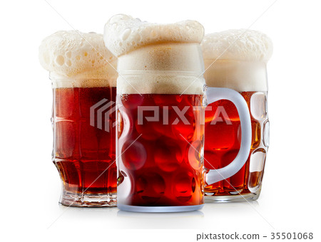 Mug of frosty dark red beer with foam 35501068