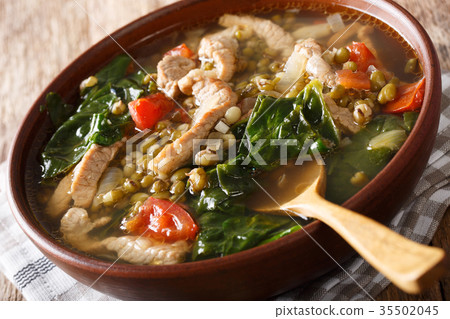 Filipino soup of beans mung with pork closeup Filipino soup of beans mung with pork closeup 35502045