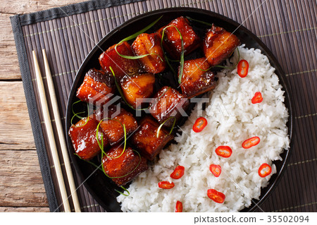 Glazed pork belly with rice close-up on a plate Glazed pork belly with rice close-up on a plate 35502094