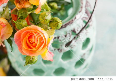 Fresh orange roses flowers in mint vase Fresh orange roses flowers in mint vase 35502250