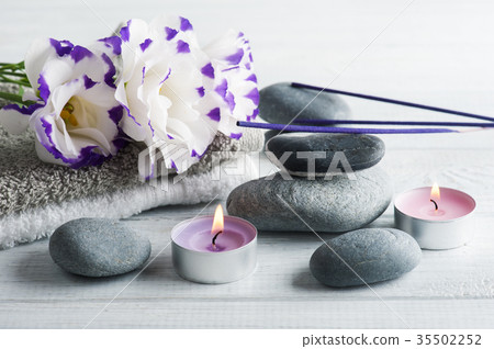 Spa composition with towels, lit candles Spa composition with towels, lit candles 35502252