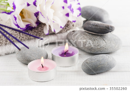 Spa composition with towels, lit candles Spa composition with towels, lit candles 35502260