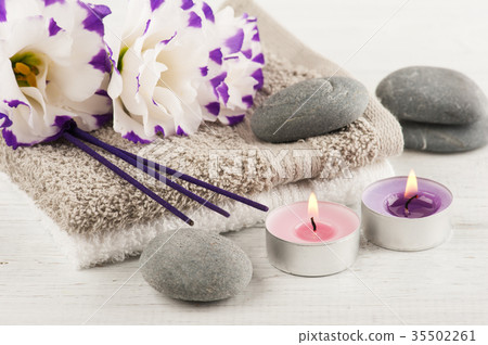 Spa composition with towels, lit candles Spa composition with towels, lit candles 35502261