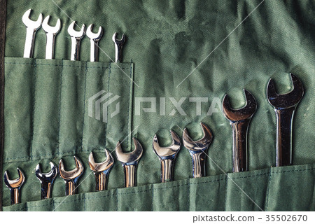 Set of combination wrenches on green fabric for re Set of combination wrenches on green fabric for re 35502670
