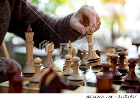 Senior man playing chess outdoor Senior man playing chess outdoor 35502917