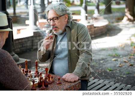 Senior male pensioner thinking of next move in Senior male pensioner thinking of next move in 35502920
