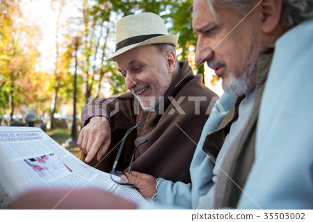 Cheerful mature pensioners discussing news from Cheerful mature pensioners discussing news from 35503002