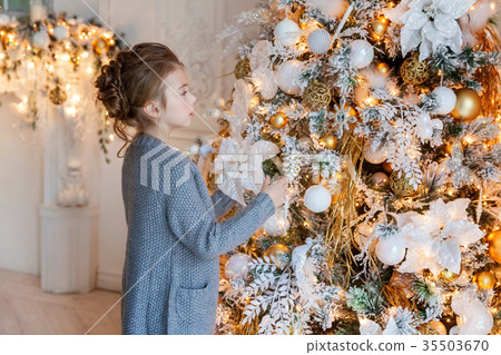 Young girl decorating Christmas tree 35503670