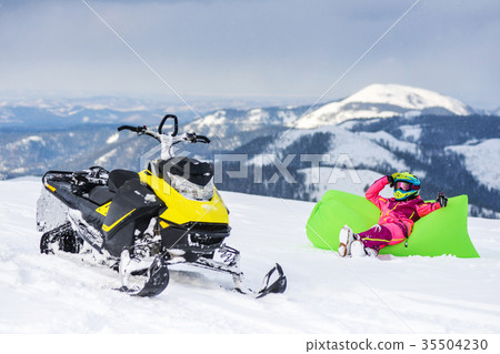 Rider on the snowmobile in the mountains. active Rider on the snowmobile in the mountains. active 35504230