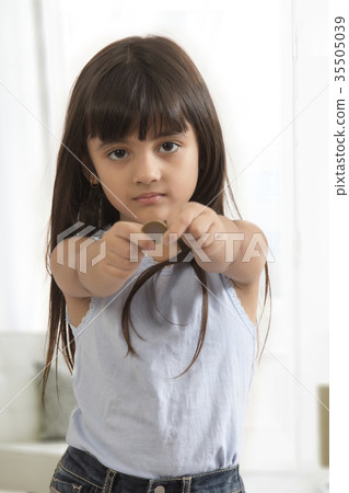 Portrait of girl holding coin Portrait of girl holding coin 35505039