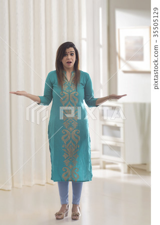 Woman surprised standing with arms outstretched Woman surprised standing with arms outstretched 35505129