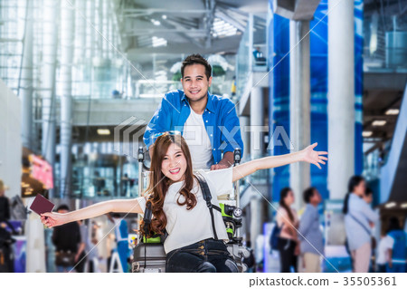 Asian couple traveler with suitcases at the airport. Lover travel and transportation with technology concept. Asian couple traveler with suitcases at the airport. Lover travel and transportation with technology concept. 35505361