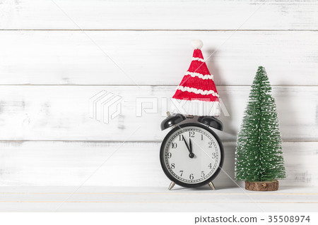 Clock and santa claus hat with christmas tree 35508974