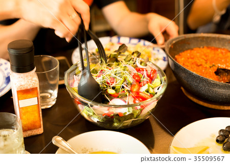 Family dinner hand holding spoon with salad 35509567