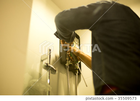 AAsian plumber fixing water heater in the bathroom 35509573