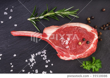 Fresh lamb cutlet on black stone background Fresh lamb cutlet on black stone background 35510086