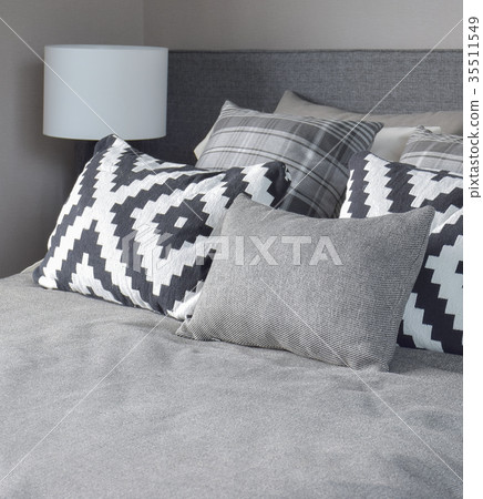 Graphic and grey pillows on classic color bedding 35511549