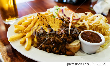 Unhealthy meal with mexican nacho chips loaded Unhealthy meal with mexican nacho chips loaded 35511645