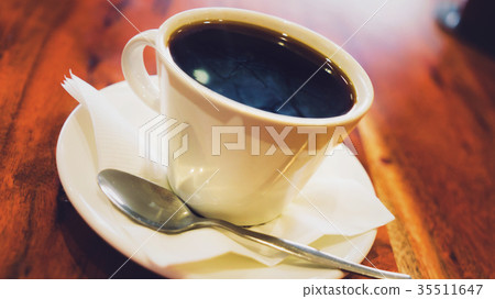 Black coffee in white cup on the brown wooden 35511647