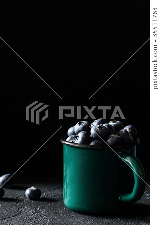 Fresh blueberries in vintage green mug Fresh blueberries in vintage green mug 35511763