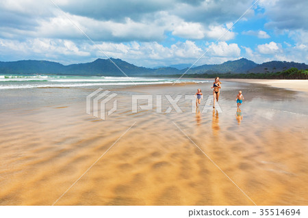 Happy family run by wide sand beach 35514694