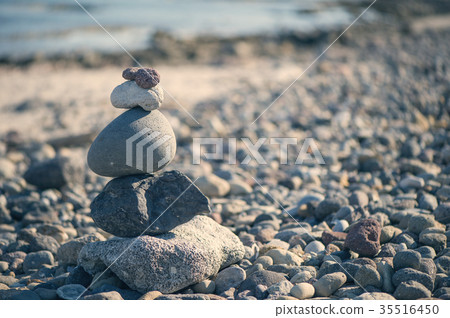 Pyramid of stones on the beach against the sea  35516450