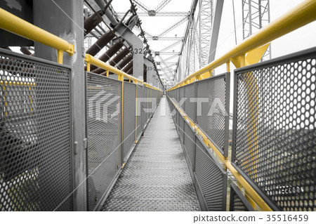 yellow railing of a transportation bridge yellow railing of a transportation bridge 35516459