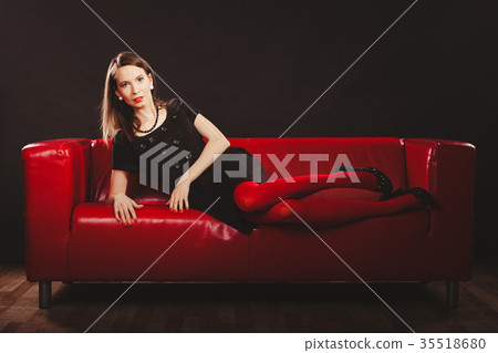 Fashion woman in red pantyhose on couch 35518680