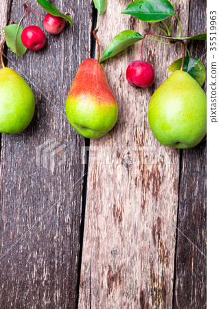 Pear and small apple on wooden rustic background Pear and small apple on wooden rustic background 35519963