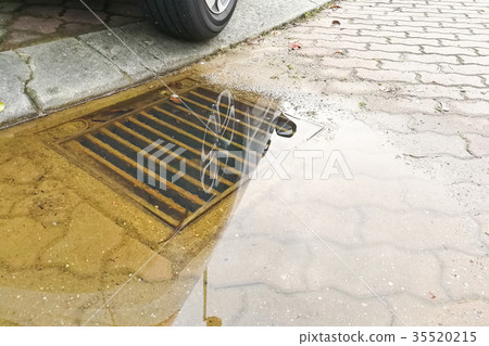 Waterlogged on street due to clogged drainage Waterlogged on street due to clogged drainage 35520215