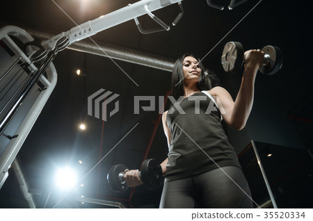 Sexy athletic young girl working out in gym 35520334