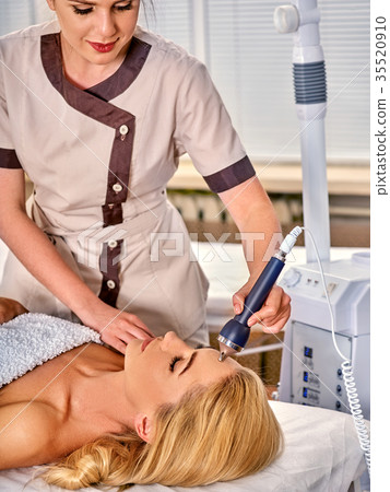 Ultrasonic facial treatment on ultrasound man face 35520910