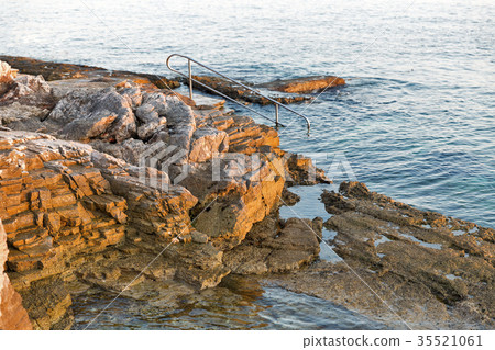 Sunset rocky beach with ladder in Istria, Croatia. 35521061