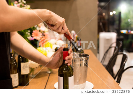 Waiter opening bottle of wine in restaurant Waiter opening bottle of wine in restaurant 35522876