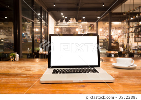Laptop with blank screen on wooden table Laptop with blank screen on wooden table 35522885