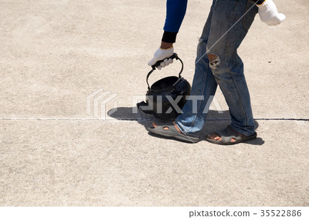 Worker is pouring asphalt for road repair Worker is pouring asphalt for road repair 35522886