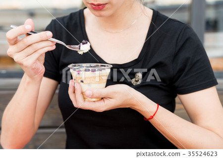 Woman eats dessert with blueberries in restaurant 35524623