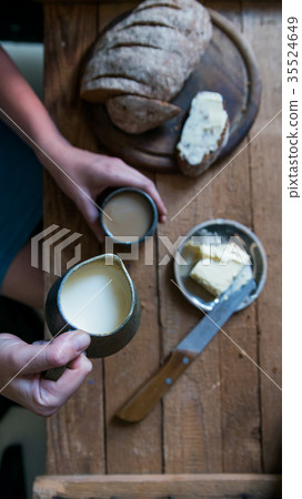 Top view woman has breakfast adds milk to coffee 35524649