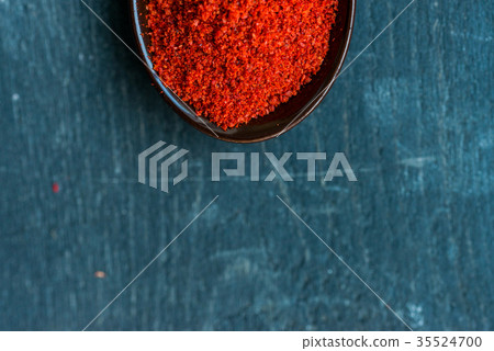 Studio shot of red paprika powder in spoon Studio shot of red paprika powder in spoon 35524700