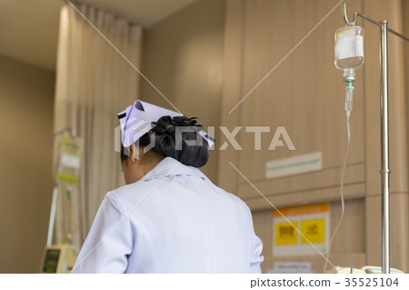 Asian nurse with saline solution drip for patient Asian nurse with saline solution drip for patient 35525104