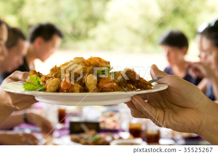 Hand holding deep fried king prawn at lunch time 35525267